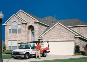 overhead door garage door technician standing outside of house