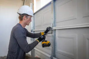Man installing garage door components